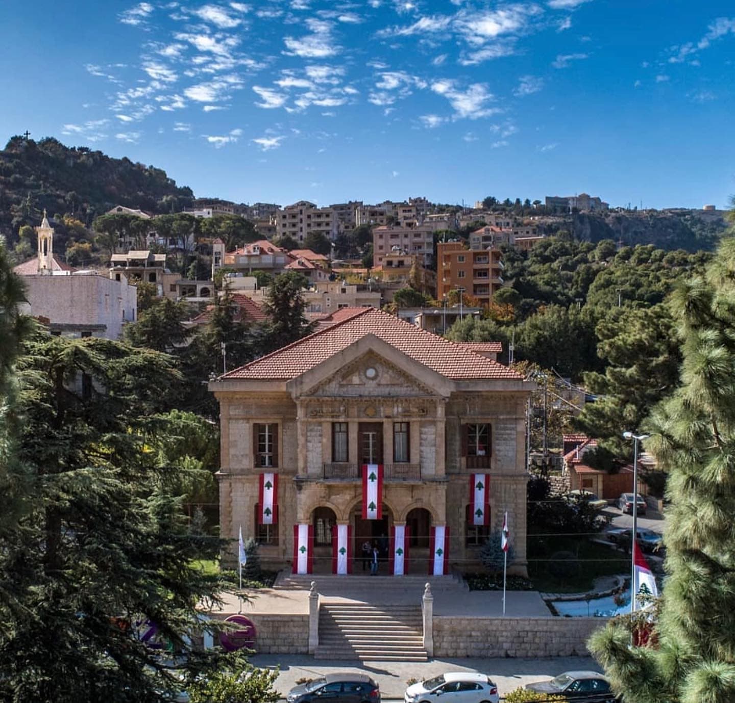 Jezzine Municipal Palace framed by pine trees and the hillside town